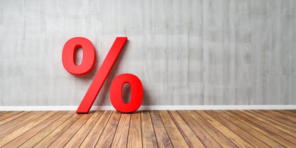 Red Percent Sign on Brown Wooden Floor Against Gray Wall - Sale Concept - 3D Illustration.