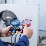 Technician is checking air conditioner ,measuring equipment for filling air conditioners.