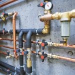 copper pipes of a private house autonomous heating system in boiler room. Plumbing services